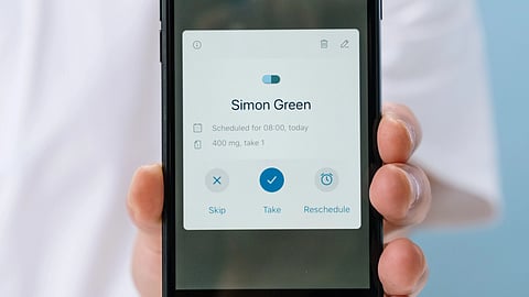 person holding phone with health app notification