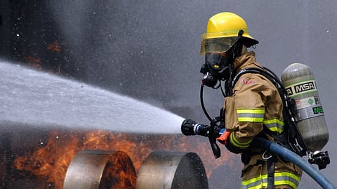 Firefighter douses a fire on a dummy aircraft