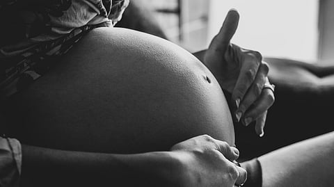 woman touching her belly