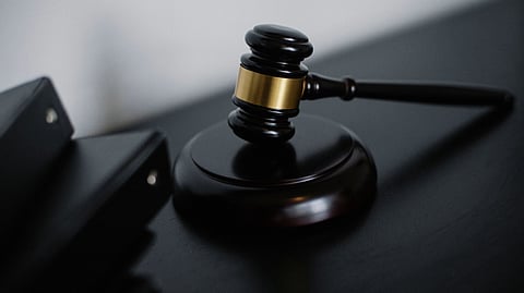 A black gavel on a black table,