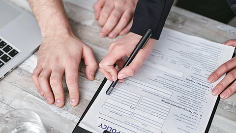 person holding a black pen