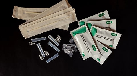 accessories and wet wipes on black background