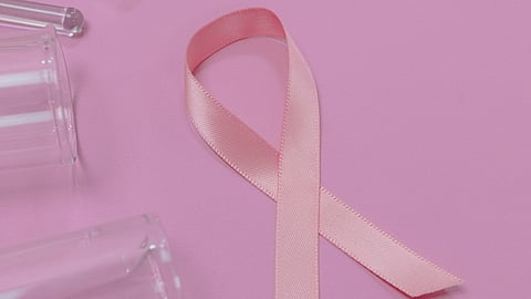 close up shot of pink ribbon on pink surface