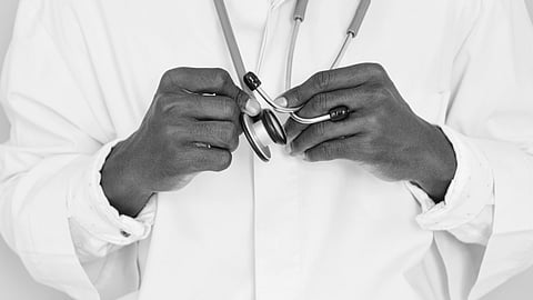 A doctor holding a stethoscope. 