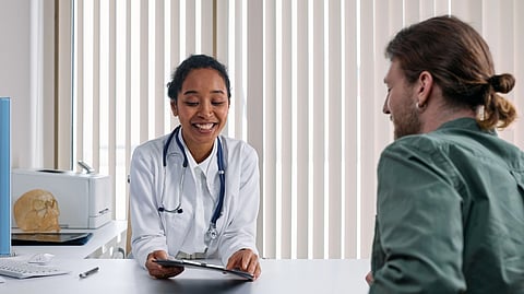 A patient sitting in front of a doctor in a clinic.