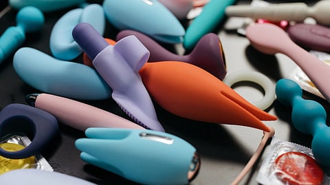 Sex toys in different colours, blue, pink, orange and purple.
