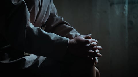 faceless business woman sitting with hands together
