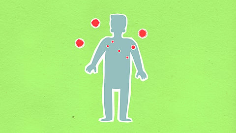An illustration of a human with red spots around and on the figurine that imitates viruses.