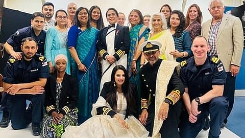 The photograph shows Honourable Captain Durdana Ansari of the British Royal Navy wearing a sari under her uniform jacket. 