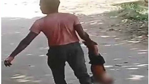 Cruelty over dowry; Father walks around holding baby upside down