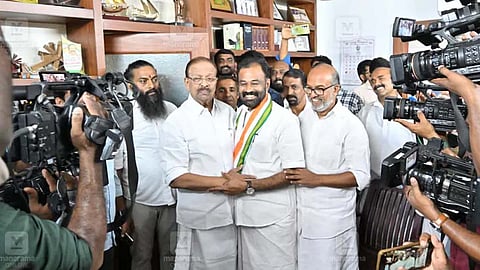 K. Sudhakaran welcomes T.O. Mohanan with a shawl