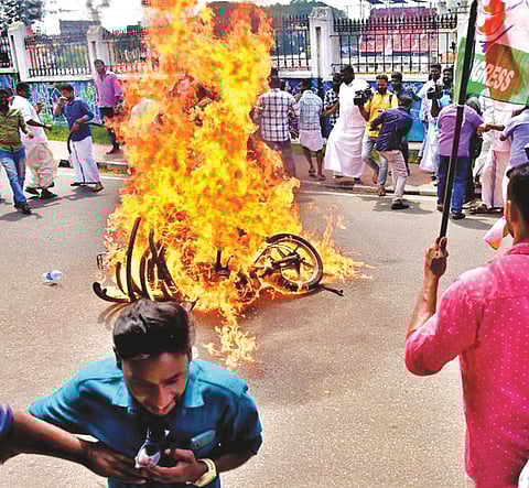 Youth Congress workers setting a motor cycle on fire in front of the Kerala Legislative Assembly building on Monday
-
