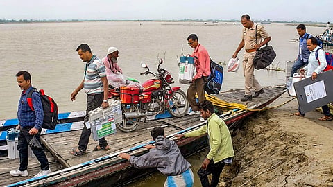 Polling officials carrying election material leave for their respective polling booths, a day before the voting in the third phase of Lok Sabha elections, Monday, May 6, 2024. 