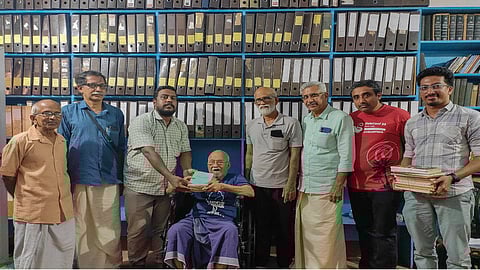 MP Parameswaran handing over his collection to Manoj Karingamadam in Thrissur on Wednesday.