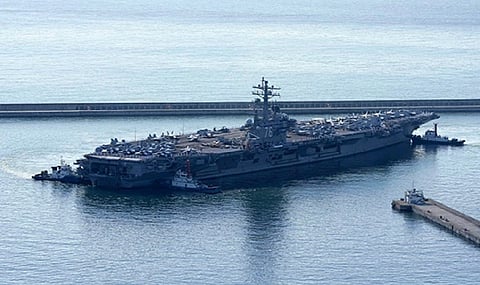 A US aircraft carrier arrived in South Korea on Sunday in a show of force, days after North Korea test-launched cruise missiles to demonstrate its counterattack capabilities.