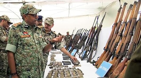 Top Chhattisgarh police officers inspect the weapons seized after the encounter between DRG jawans and Naxals in Abujhmad in Narayanpur on May 21.
