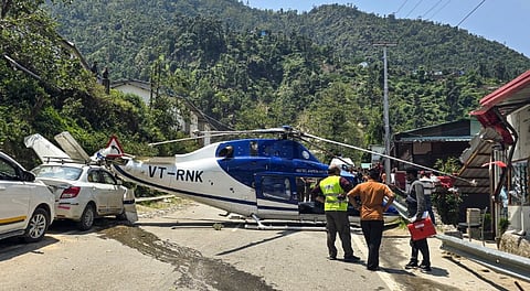 Damaged tail boom of a Kedarnath Dham-bound helicopter lies atop a car after it made an emergency landing at Badasu area, in Rudraprayag district, Uttarakhand, Saturday, June 7, 2025.