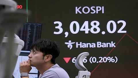 Asian shares are mostly down as Trump's tariff deadline looms, pressure steps up 