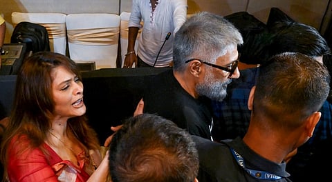 Bollywood film director Vivek Agnihotri and his wife and actor Pallavi Joshi being escorted by security personnel after the trailer launch of his controversial film 'The Bengal Files', based on the 1946 Calcutta Riots, was allegedly stopped by the police, in Kolkata, West Bengal, Saturday, Aug. 16, 2025.