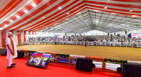 In this image received on Aug. 25, 2025, Prime Minister Narendra Modi waves to the gathering during the inauguration and foundation stone laying ceremony of development projects, at Khodaldham ground, in Ahmedabad.
