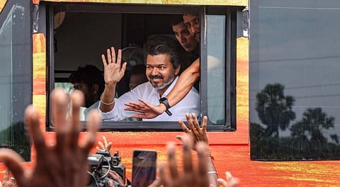 Actor and Tamilaga Vettri Kazhagam (TVK) founder Vijay waves to the people during a public rally, in Nagapattinam district, Tamil Nadu, Saturday, Sept. 20, 2025.