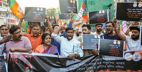 BJP supporters raise slogans as they hold a protest over the alleged gang rape in Durgapur of a medical college student, in Kolkata, Monday, Oct. 13, 2025.