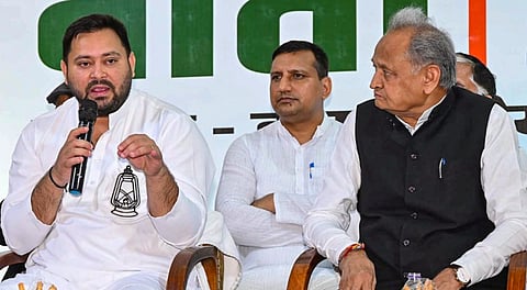 RJD leader and Leader of Opposition in Bihar Assembly Tejashwi Yadav in presence of Congress leader Ashok Gehlot addresses INDIA bloc press conference, in Patna, Thursday, Oct. 23, 2025. 