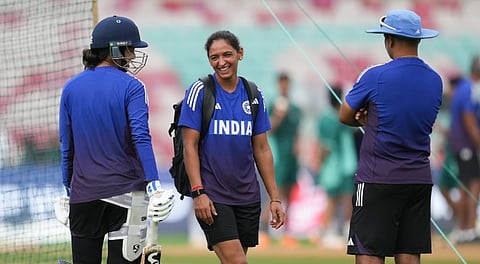 India's captain Harmanpreet Kaur with teammate Smriti Mandhana and head coach Amol Muzumdar during a training session ahead of the ICC Women's World Cup 2025 final cricket match between India and South Africa, at DY Patil Stadium, in Navi Mumbai, Saturday, Nov. 1, 2025.