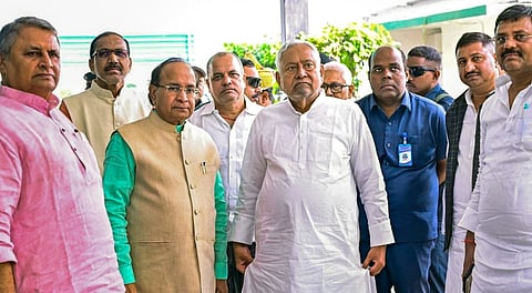 Bihar CM Nitish Kumar with party workers at a polling stattion during the second and final phase of the Bihar Assembly elections, Tuesday, Nov. 11, 2025.