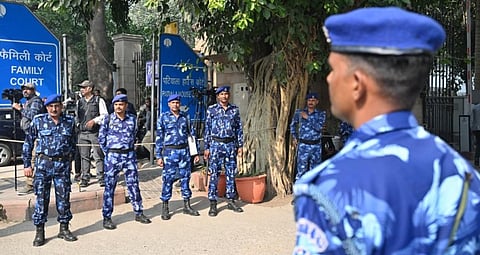 Security personnel stand outside Patiala House Court after receiving a bomb threat in New Delhi on November 18, 2025.