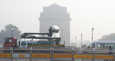 An NDMC vehicle mounted with an anti-smog gun moves past India Gate, in New Delhi, Saturday, Nov. 22, 2025.