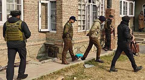 Police with CRPF personnel carry out a search at the residence of a person linked to banned Jamaat-e-Islami, in Pulwama, Thursday, Nov. 27, 2025.
