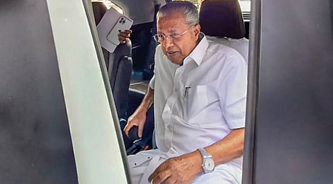 Kerala Chief Minister Pinarayi Vijayan gets into his car after a press conference, in Kozhikode, Sunday, Dec. 7, 2025.