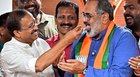 Kerala BJP President Rajeev Chandrasekhar, front right, being offered sweets by senior party leader V Muraleedharan, left, during the celebration of the party-led NDA�s victory from Trivandrum corporation.