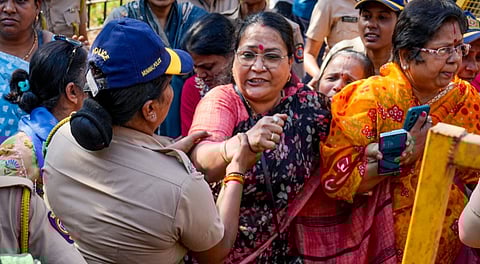 Police personnel detain activists as Hindu organisations stage a protest near the Deputy High Commission of Bangladesh against alleged attacks on minority communities in Bangladesh, in Mumbai, Tuesday, Dec. 23, 2025. 
