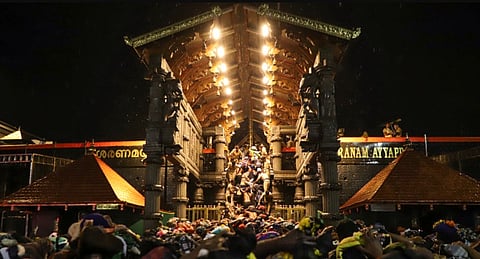 People wait in a queue to offer prayers to Lord Ayyappa at the Sabarimala Temple, in Pathanamthitta district, Kerala, Saturday, Dec. 13, 2025.