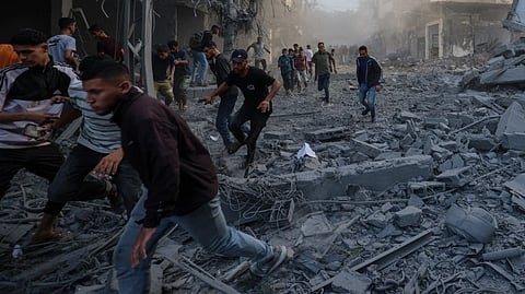 People seeking cover during a Gaza airstrike following a ceasefire violation by Israel.
