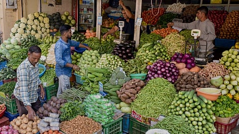 A vendor sells vegetables at a market