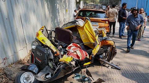 People gather near damaged vehicles after a slab of the girder bridge of under-construction metro rail line 4 collapsed on a few vehicles, killing at least one person and injuring three others, at Mulund area, in Mumbai, Maharashtra, Saturday, Feb. 14, 2026.