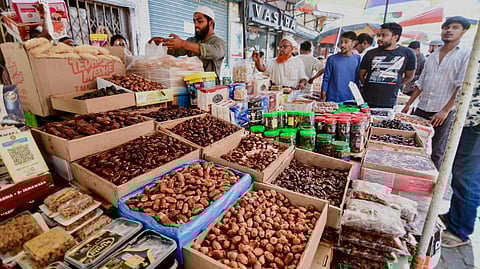 People shop for dates and other dry fruits amid Ramadan festivities, in Guwahati, Wednesday, Feb. 18, 2026.