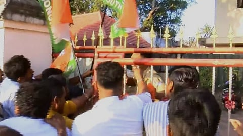 Youth Congress workers stage a protest outside Kerala Health Minister Veena George's residence, bearing wreaths.