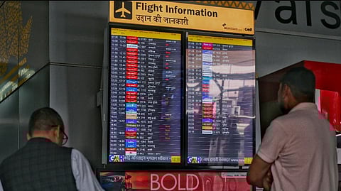 Passengers check flight information at New Delhi’s Indira Gandhi International Airport on March 3, 2026, amid ongoing Middle East tensions.