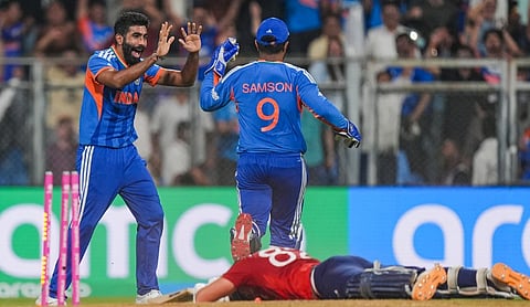 India's Jasprit Bumrah celebrates the dismissal of England's Jacob Bethell, bottom, with teammate Sanju Samson during the ICC Men's T20 World Cup 2026 second semifinal cricket match between India and England at Wankhede Stadium, in Mumbai, Thursday, March 5, 2026. 