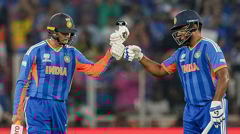 India's Abhishek Sharma, left, celebrates with teammate Sanju Samson after scoring a half century during the ICC Men's T20 World Cup 2026 final cricket match between India and New Zealand at Narendra Modi Stadium, in Ahmedabad, Gujarat, Sunday, March 8, 2026.