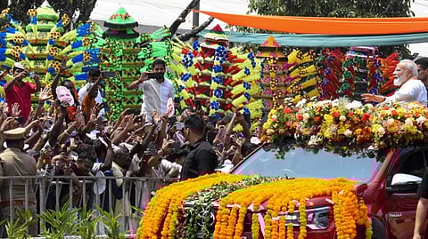 Prime Minister Narendra Modi greets supporters during a roadshow, in Kochi, Wednesday, March 11, 2026.
