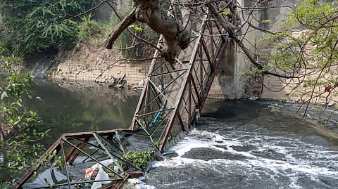 The collapsed foot overbridge where a woman died after falling into the drain beneath, in Roop Nagar, New Delhi, Tuesday, March 17, 2026.