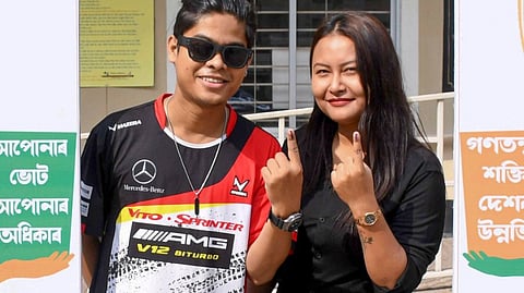 Young voters show their ink-marked fingers after casting votes in the Assam Assembly elections, at a polling station in Guwahati, Thursday, April 9, 2026.