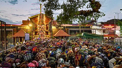 Rush of people as they wait to offer prayers at the Sabarimala temple ahead of the 'Makaravilakku' festival, in Pathanamthitta district, Kerala, Tuesday, Jan. 13, 2026.