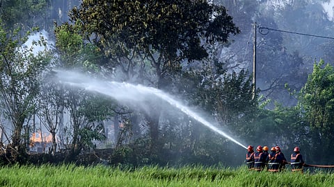 Fire and rescue personnel douse flames after a fire broke out at a fireworks manufacturing unit at Mundathikode village, in Thrissur district, Tuesday, April 21, 2026.