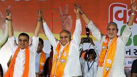 Gujarat Chief Minister Bhupendra Patel, centre, Deputy Chief Minister Harsh Sanghavi, left, and Gujarat BJP Chief Jagdish Panchal during BJP's election results celebration following the party's strong performance in Gujarat's local body polls, in Ahmedabad, Tuesday, April 28, 2026. 